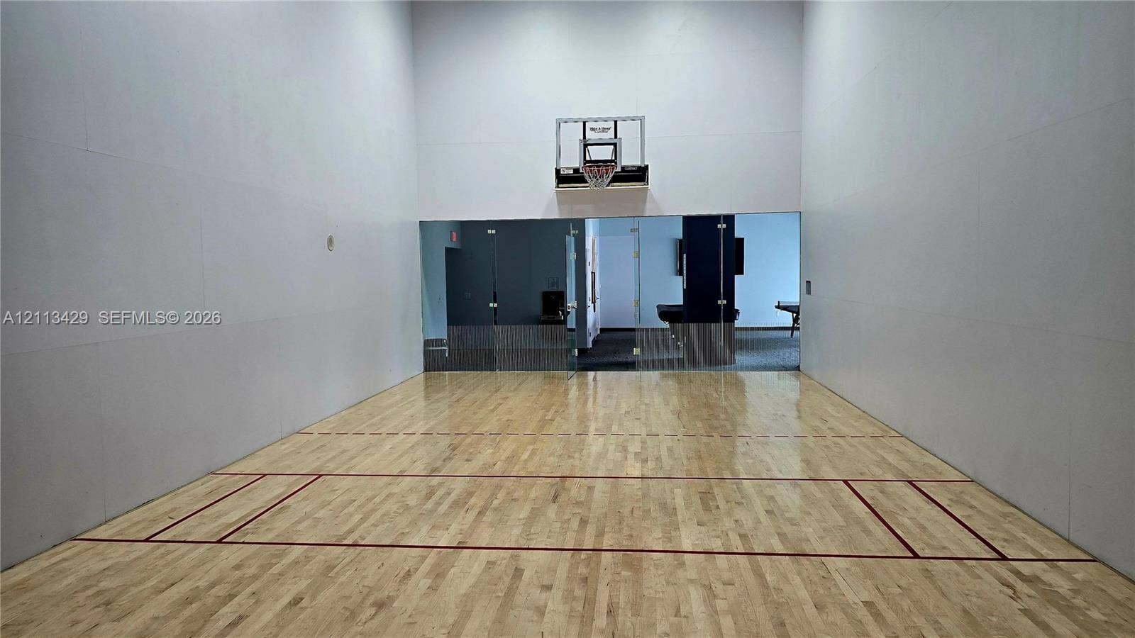 6365 Collins Avenue, #909, Miami Beach, FL 33141 Indoor court featuring wood-finish flooring, high ceilings, integrated wall-mounted basketball hoop, and glass-paneled partition