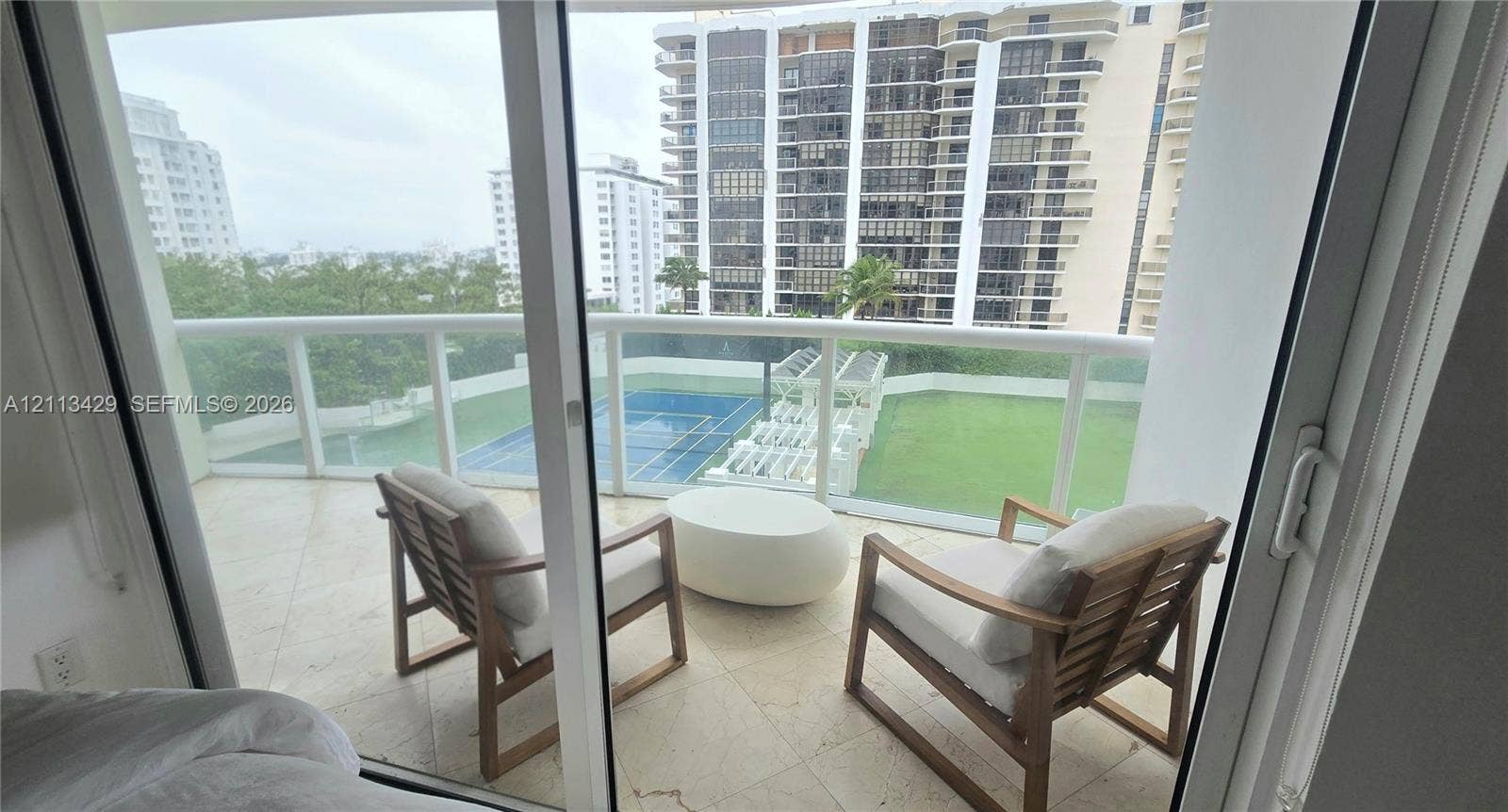 6365 Collins Avenue, #909, Miami Beach, FL 33141 Private balcony featuring tile flooring and a glass-paneled railing