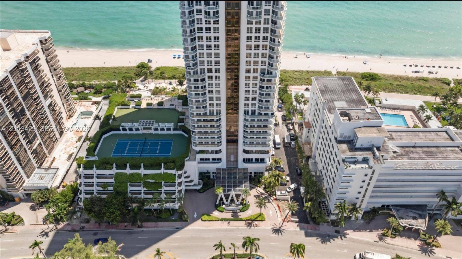 6365 Collins Avenue, #909, Miami Beach, FL 33141 High-rise building featuring direct beach access, an outdoor tennis court, and a multi-level parking structure