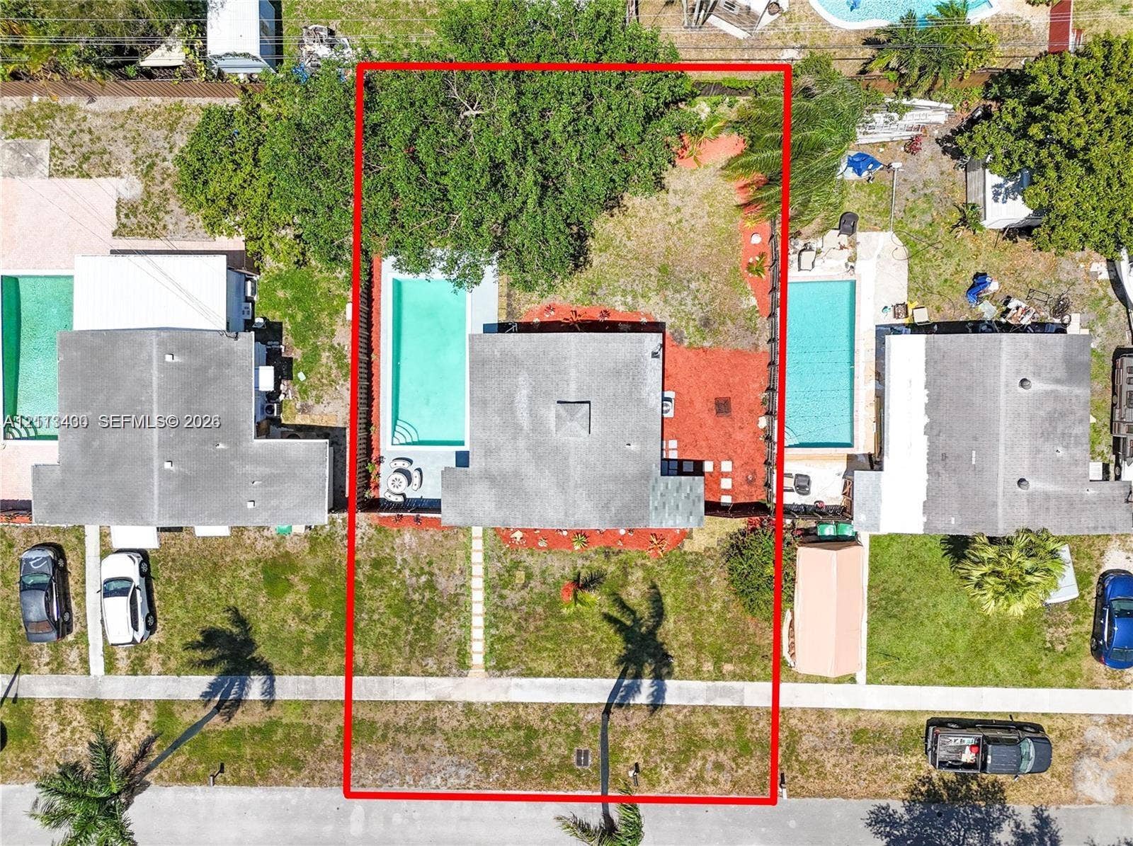 5621 SW 38th Court, Davie, Davie, FL 33314 Aerial perspective of property featuring an in-ground swimming pool, concrete patio, mature trees, and perimeter fencing