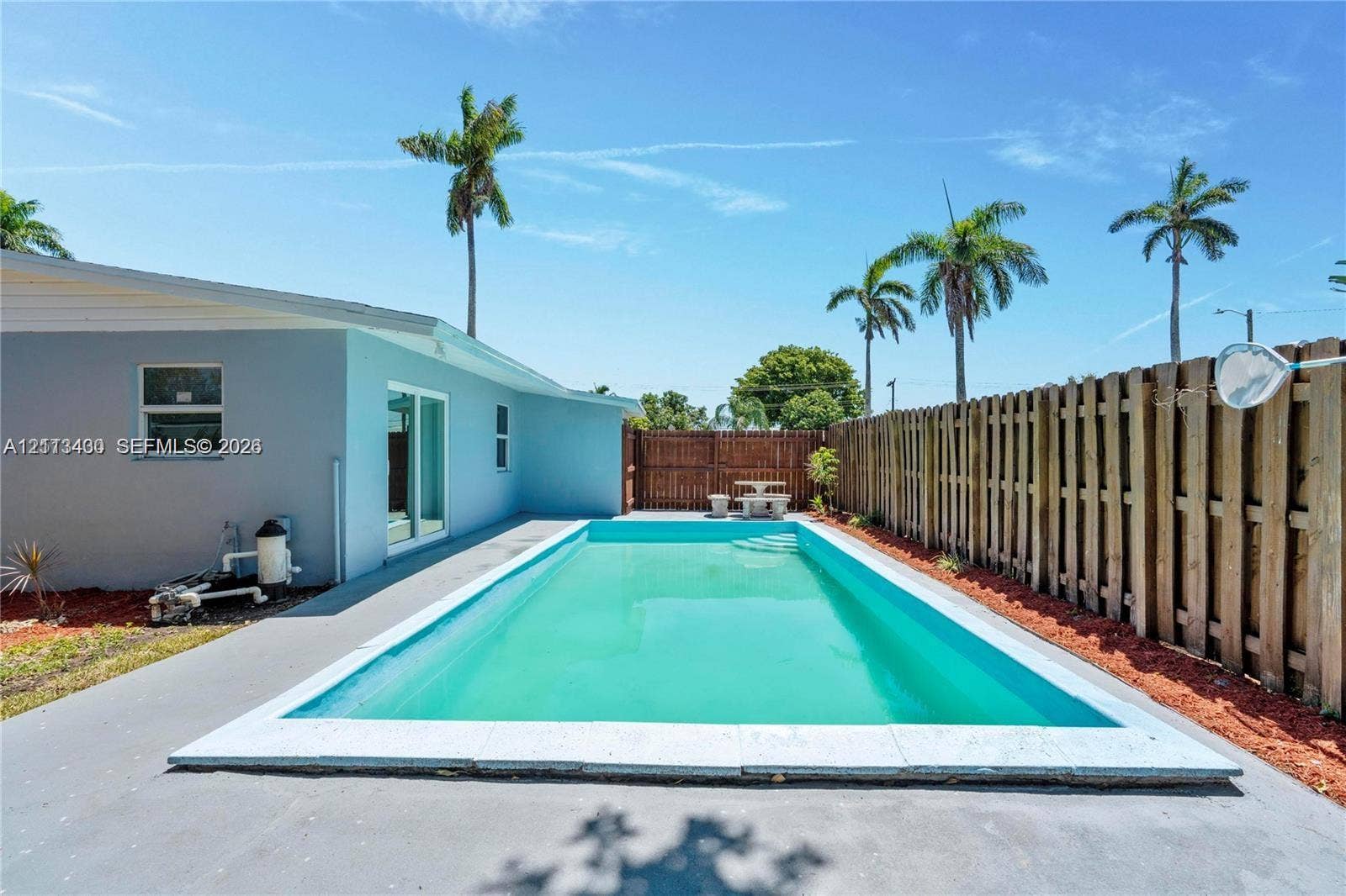 5621 SW 38th Court, Davie, Davie, FL 33314 In-ground swimming pool with concrete decking, enclosed by a full-height wood privacy fence