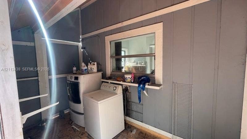 Utility area featuring vertical panel wall cladding, fixed window with casing, and integrated shelving ledge