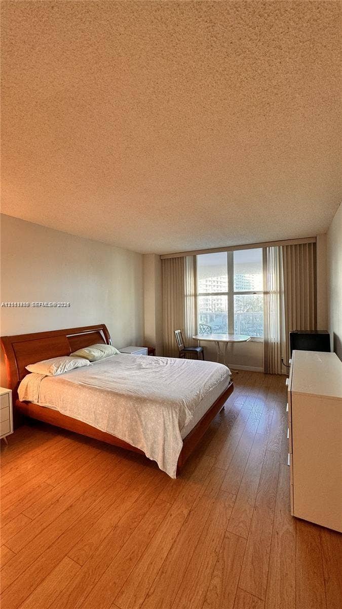 3800 S Ocean Drive, #416, Hollywood, FL 33019 Wood-finish flooring, floor-to-ceiling windows, and vertical blinds