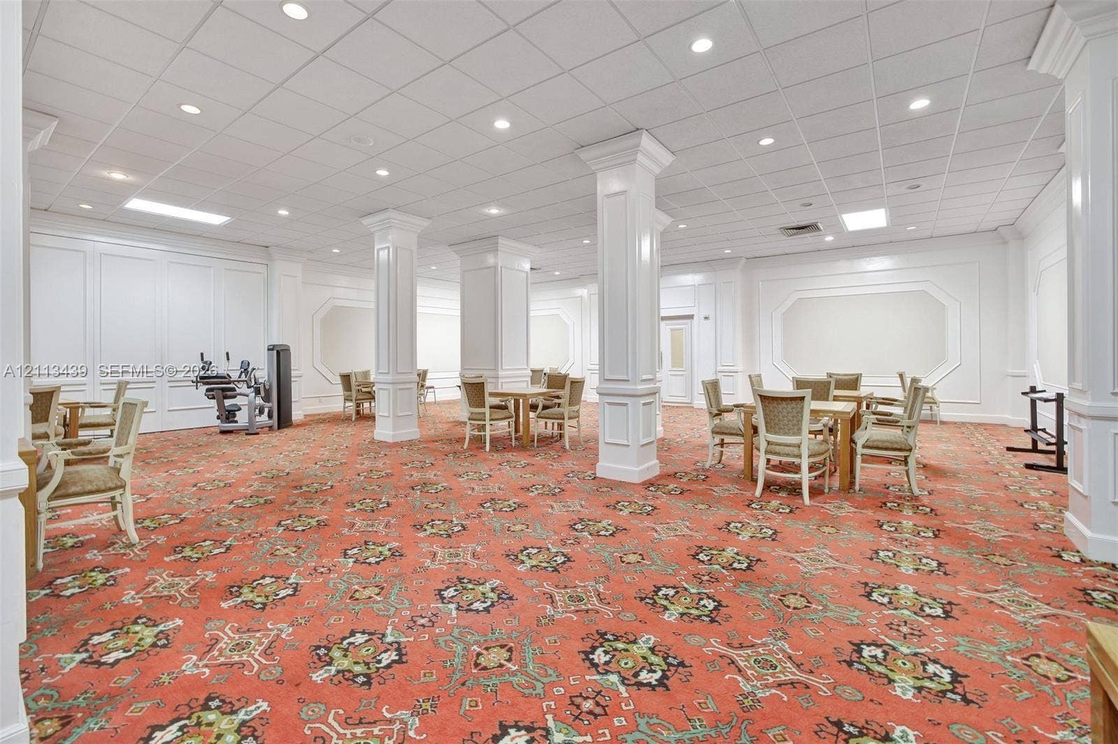 3800 S Ocean Drive, #416, Hollywood, FL 33019 Open-concept interior featuring structural columns with wainscoting detail, wall molding, recessed lighting, and a drop ceiling