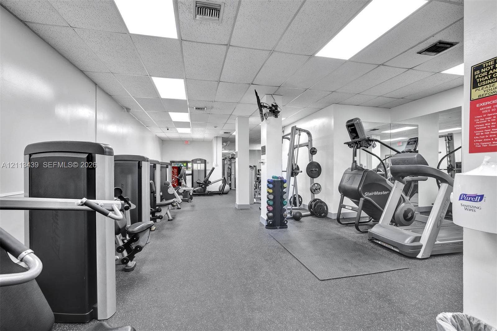 3800 S Ocean Drive, #416, Hollywood, FL 33019 Fitness room featuring rubberized flooring, recessed fluorescent lighting, and mirrored wall panels
