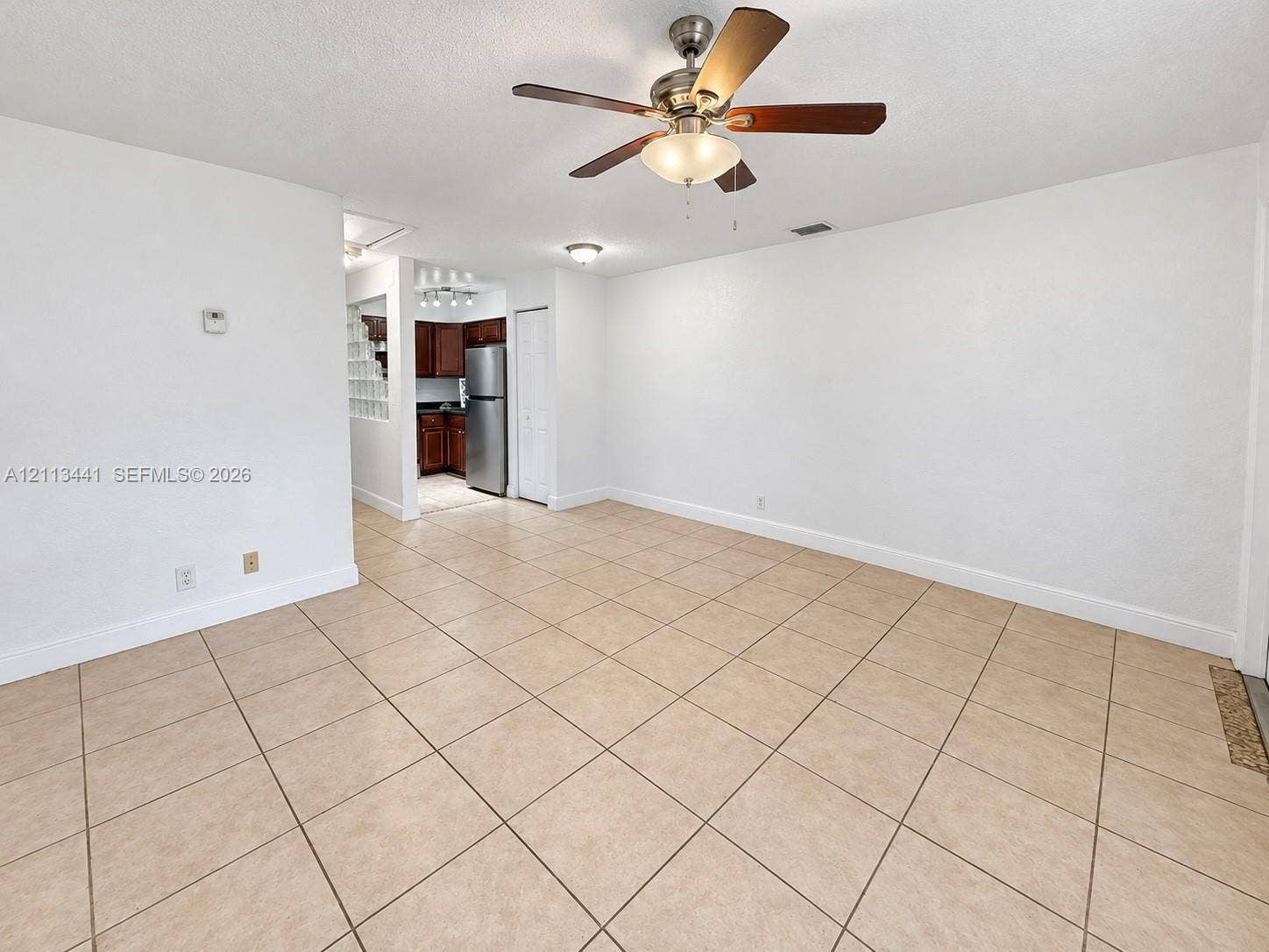 80 NE 36th Court, #82, Oakland Park, Oakland Park, FL 33334 Neutral ceramic tile flooring, ceiling fan with integrated lighting, and smooth-finish walls