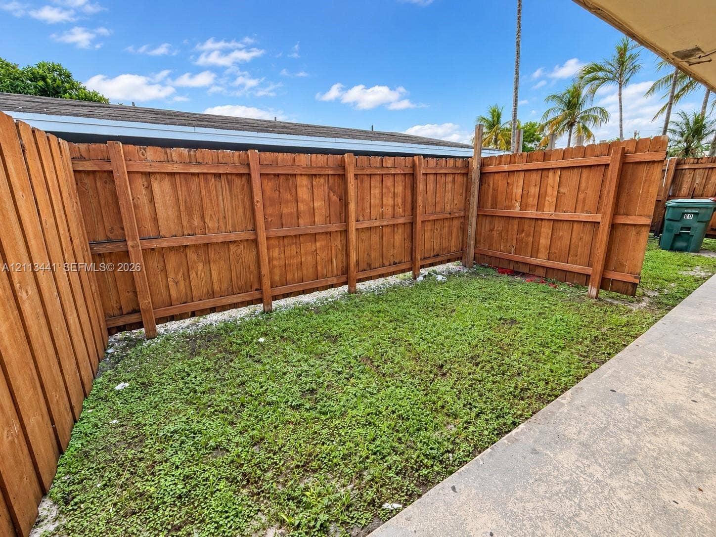 80 NE 36th Court, #82, Oakland Park, Oakland Park, FL 33334 Outdoor space featuring a concrete patio, wood privacy fencing, and a grass lawn