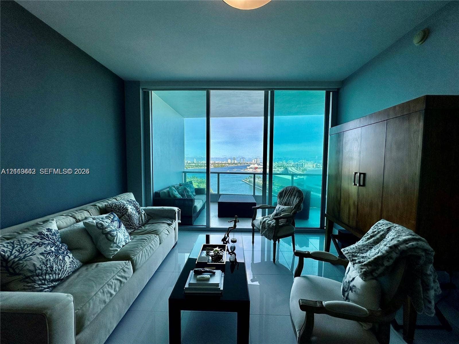 900 Biscayne Boulevard, #1903, Miami, Miami, FL 33132 Floor-to-ceiling glass sliding doors opening to a covered balcony, large-format tile flooring, and panoramic water scenery