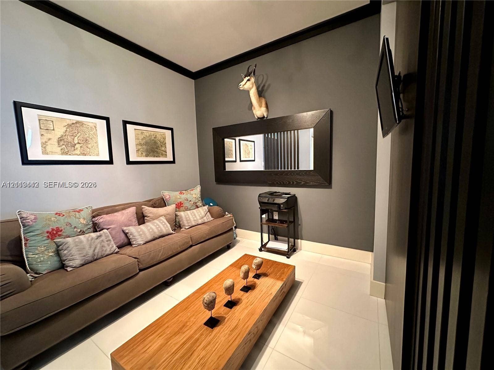 900 Biscayne Boulevard, #1903, Miami, Miami, FL 33132 Interior space featuring large-format light-toned flooring, high-contrast dark crown molding, and a prominent decorative wall-mounted mirror