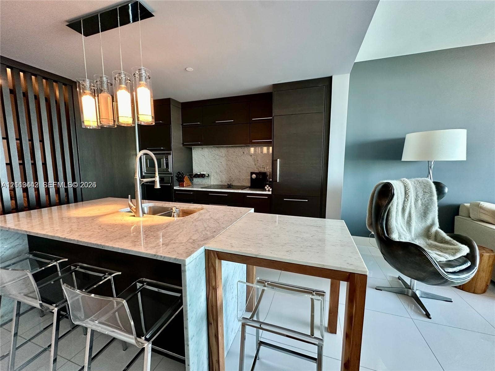 900 Biscayne Boulevard, #1903, Miami, Miami, FL 33132 Kitchen featuring dark cabinetry, stone countertops with a waterfall edge, a built-in cooktop, integrated refrigeration, and a multi-light pendant fixture