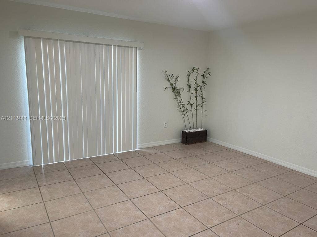 5705 NW 109th Avenue, #47, Doral, Doral, FL 33178 Ceramic tile flooring and white vertical sliding glass patio doors