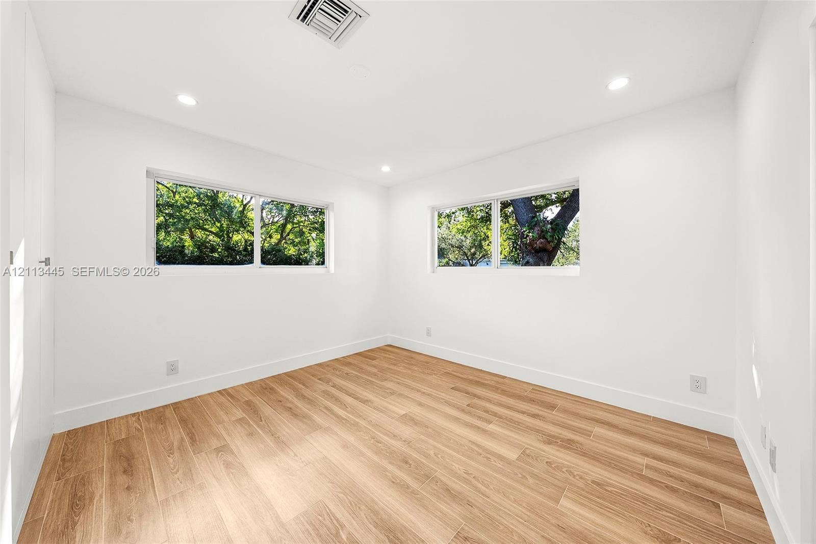 6951 SW 134th Street, Pinecrest, Pinecrest, FL 33156 Room featuring wood-finish flooring, recessed lighting, and dual horizontal windows