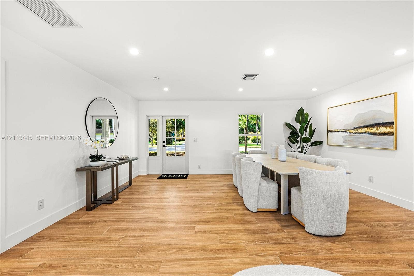 6951 SW 134th Street, Pinecrest, Pinecrest, FL 33156 Open interior featuring wood-finish flooring, recessed lighting, and a white-framed glass paneled entry door