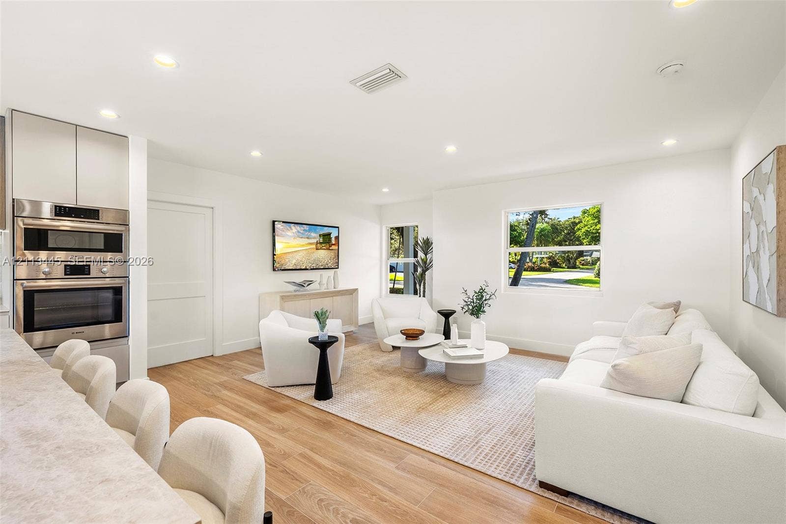6951 SW 134th Street, Pinecrest, Pinecrest, FL 33156 Living area featuring wood-finish flooring, recessed lighting, and integrated stainless steel double wall ovens