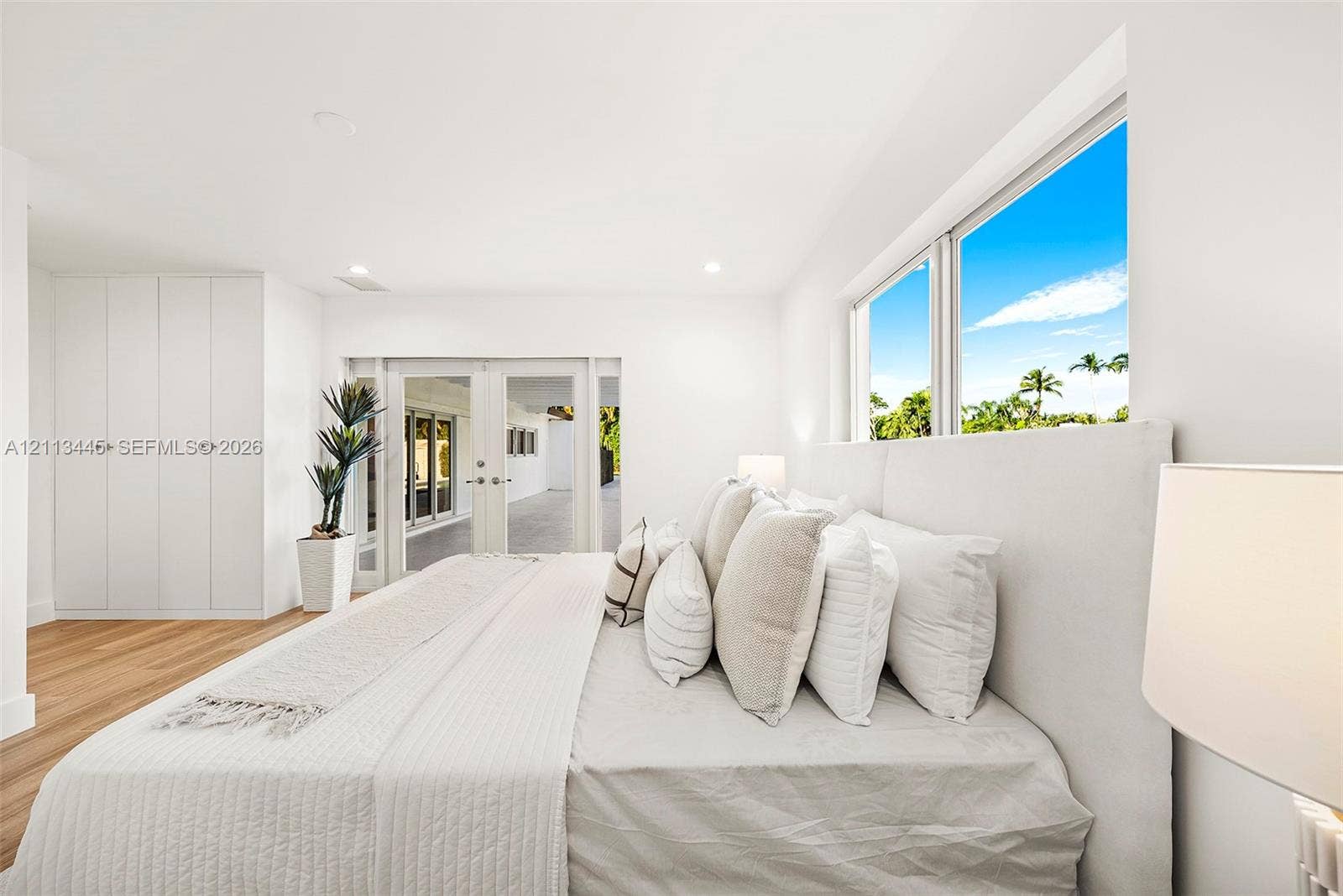6951 SW 134th Street, Pinecrest, Pinecrest, FL 33156 Room featuring wood-finish flooring, built-in floor-to-ceiling cabinetry, recessed lighting, and double-pane glass doors providing external access