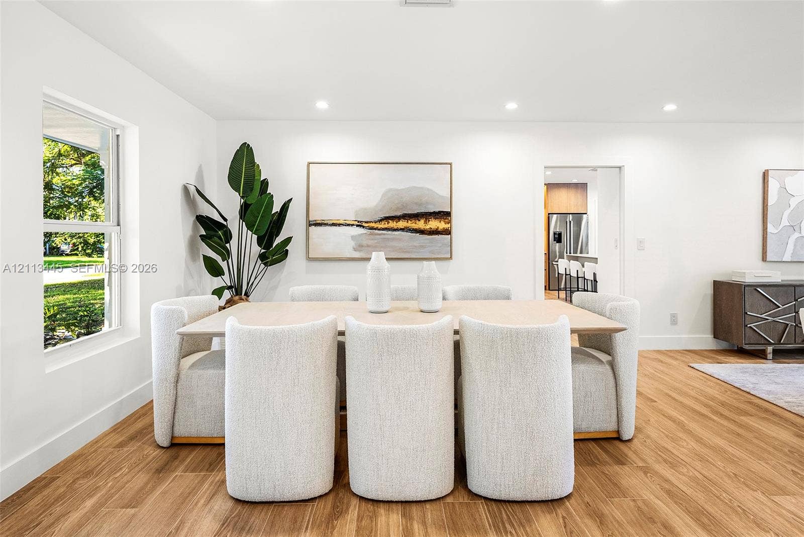6951 SW 134th Street, Pinecrest, Pinecrest, FL 33156 Bright, neutral interior featuring wood-finish flooring, recessed lighting, and large-format window