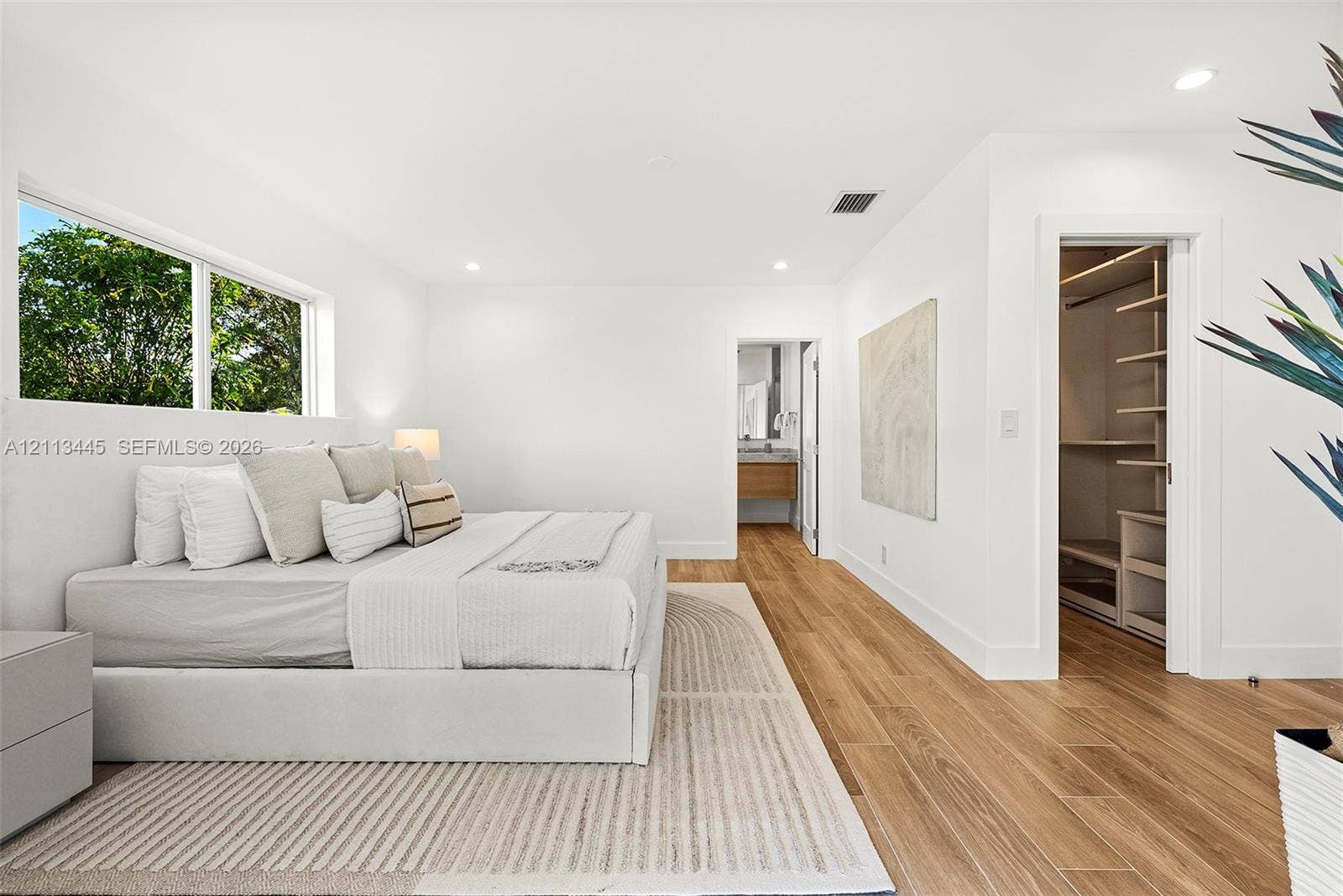 6951 SW 134th Street, Pinecrest, Pinecrest, FL 33156 Interior space featuring wood-finish flooring, recessed lighting, and a walk-in closet with built-in shelving