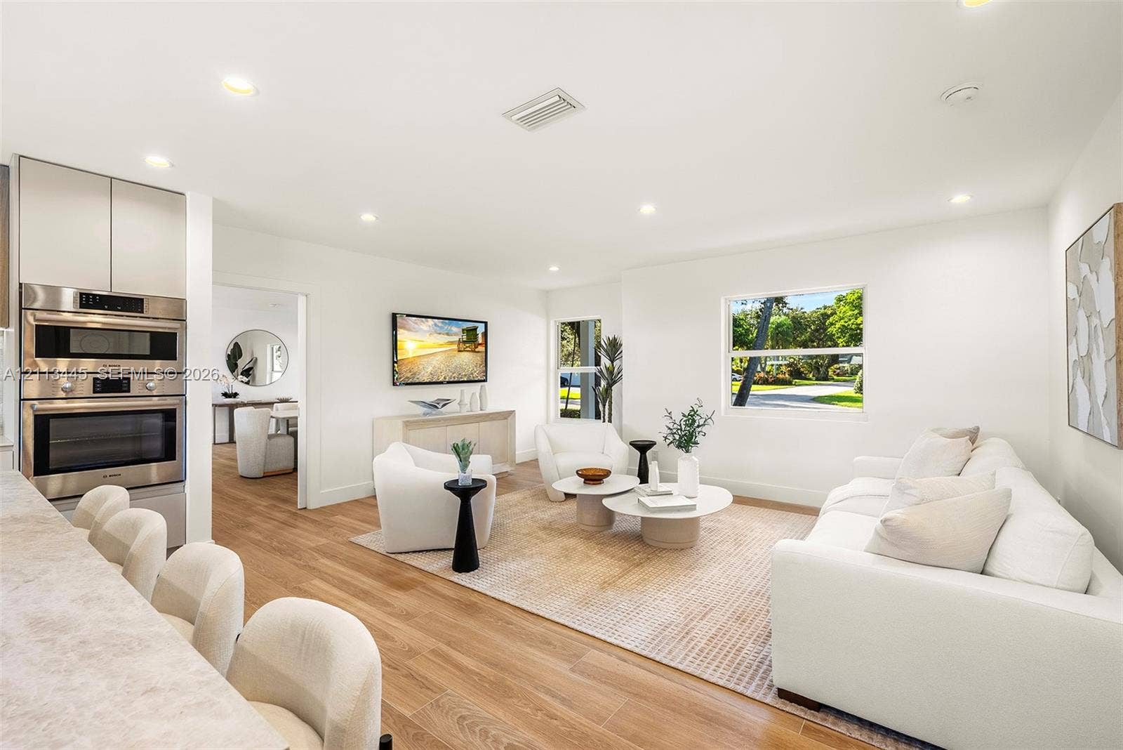 6951 SW 134th Street, Pinecrest, Pinecrest, FL 33156 Open-concept interior featuring wood-finish flooring, recessed lighting, and a built-in stainless steel double wall oven