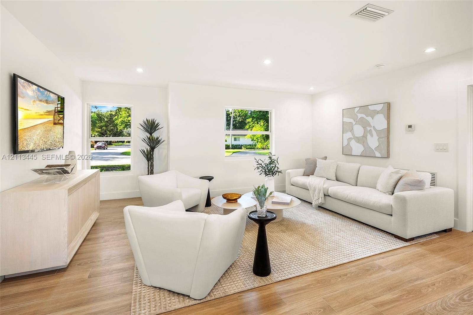 6951 SW 134th Street, Pinecrest, Pinecrest, FL 33156 Living area featuring wood-finish flooring, recessed lighting, and multiple windows