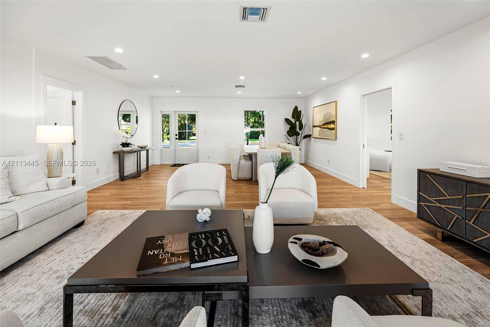6951 SW 134th Street, Pinecrest, Pinecrest, FL 33156 Open-concept interior featuring wood-finish flooring, recessed lighting, and a glass-paneled entry door