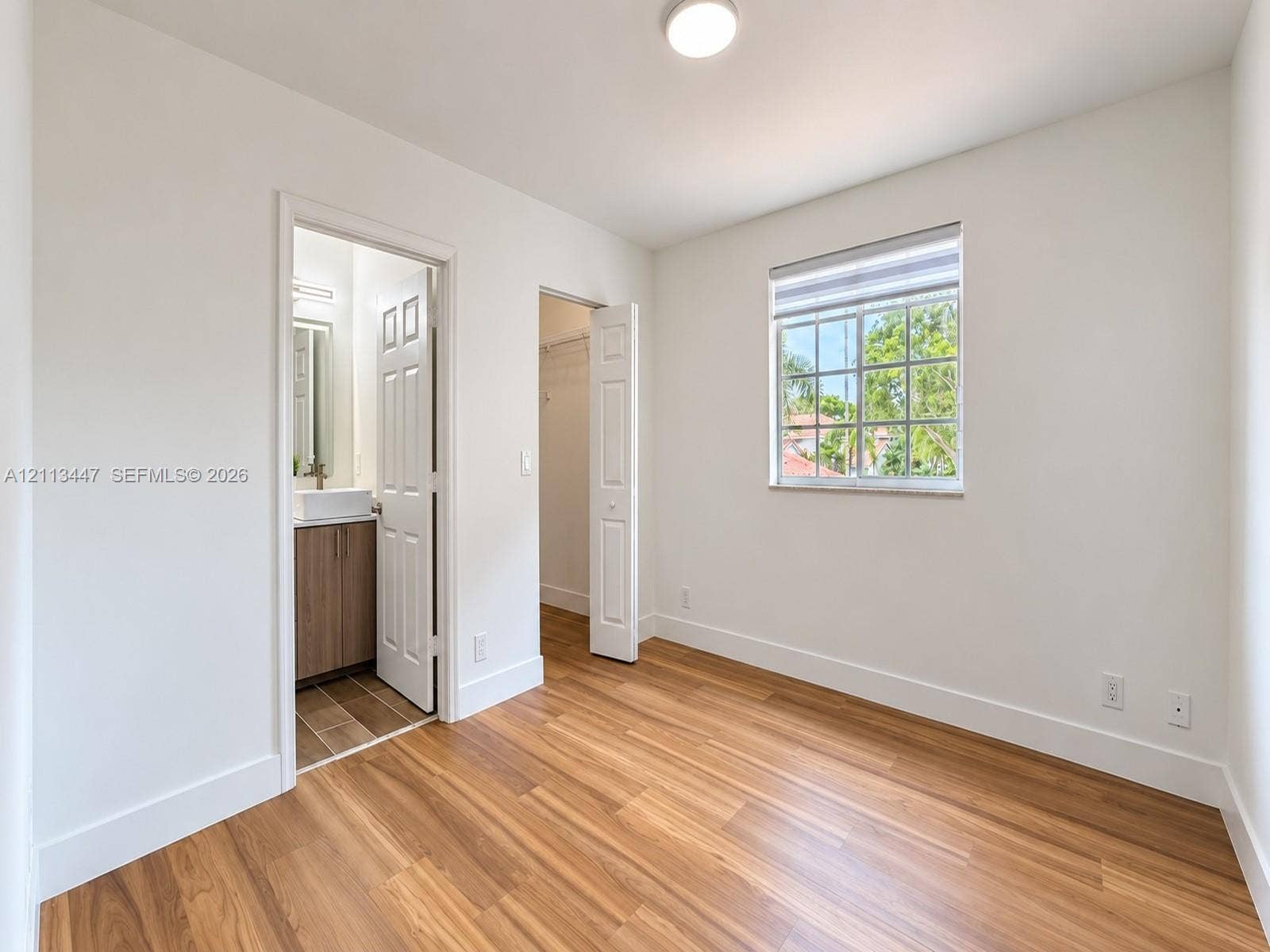 3818 San Simeon Circle, #3818, Weston, Weston, FL 33331 Room with luxury laminated flooring, recessed lighting, grid-pattern window, and two doors providing interior access