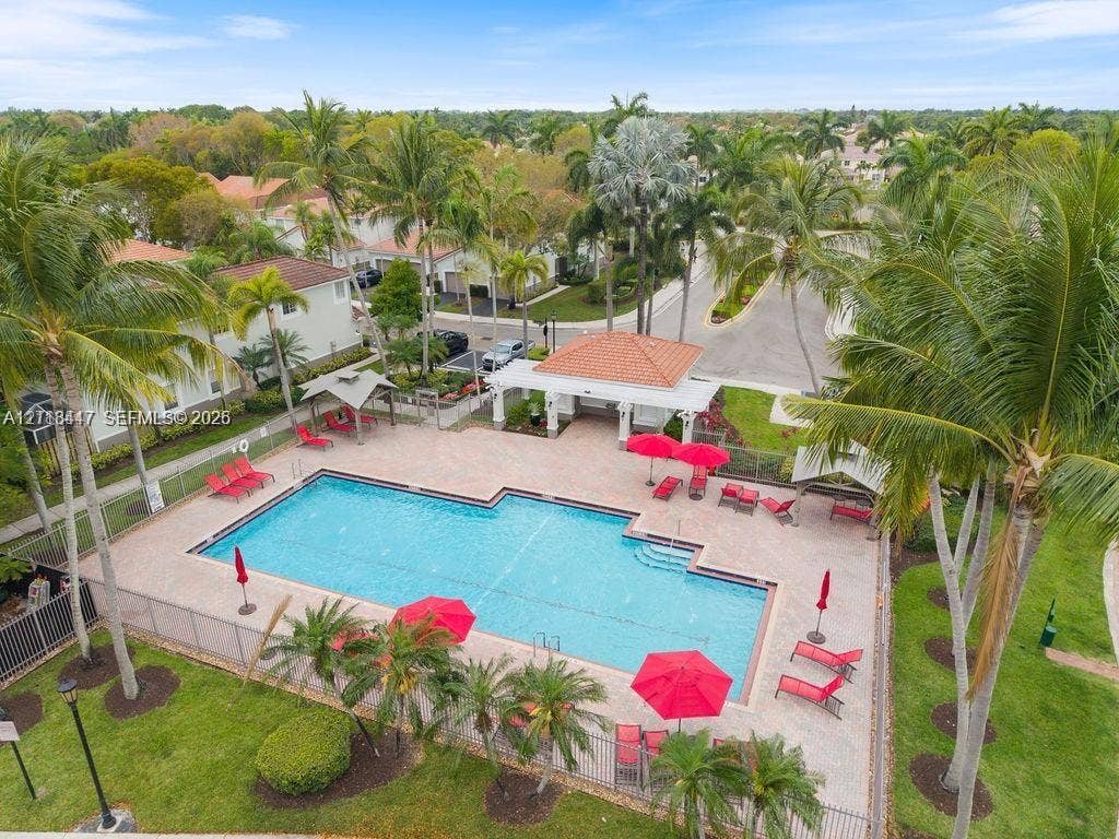 3818 San Simeon Circle, #3818, Weston, Weston, FL 33331 Swimming pool with paver decking, covered pavilion with clay-tile roof, and surrounding palm tree landscaping