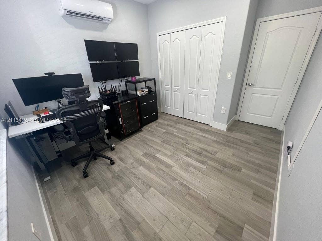 5083 SW 160th Avenue, Miami, Miami, FL 33185 Wood-finish flooring, wall-mounted ductless air conditioning unit, bi-fold closet doors, and interior arched-panel door