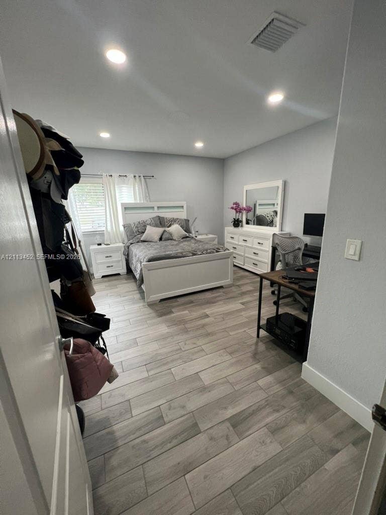 5083 SW 160th Avenue, Miami, Miami, FL 33185 Room featuring wood-finish flooring, recessed lighting, and horizontal window blinds