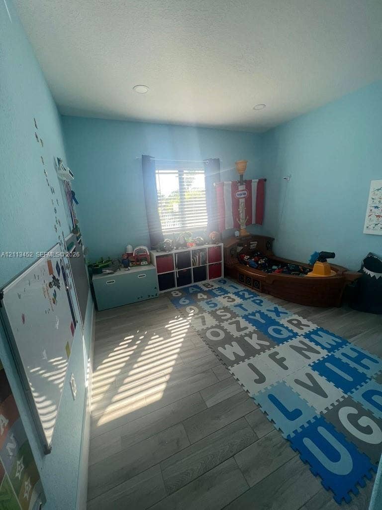 5083 SW 160th Avenue, Miami, Miami, FL 33185 Interior space featuring wood-finish flooring, recessed lighting, and a window with horizontal blinds