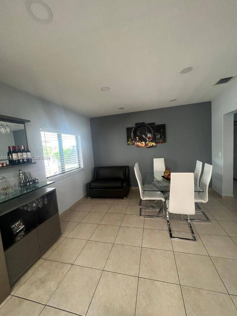 5083 SW 160th Avenue, Miami, Miami, FL 33185 Ceramic tile flooring, built-in recessed lighting, and a neutral color palette featuring a dark gray accent wall