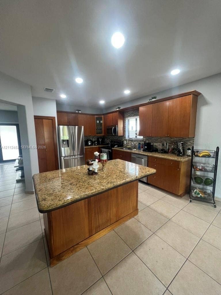 5083 SW 160th Avenue, Miami, Miami, FL 33185 Kitchen featuring a center island, stone-finish countertops, wood-finish cabinetry, stainless steel appliances, and recessed lighting