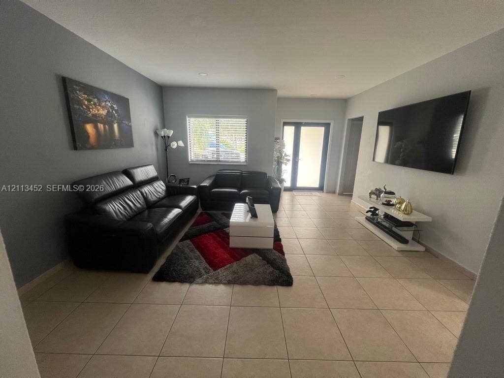 5083 SW 160th Avenue, Miami, Miami, FL 33185 Neutral-toned interior featuring large-format ceramic tile flooring, recessed ceiling lighting, and a dual-pane entry door
