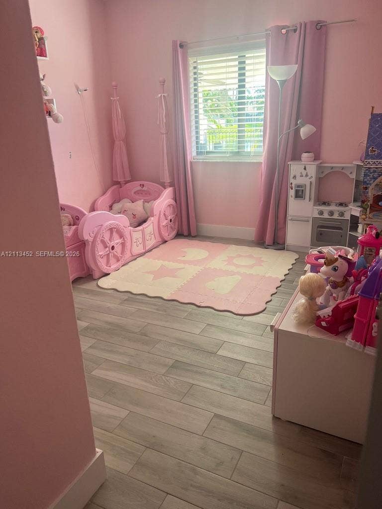 5083 SW 160th Avenue, Miami, Miami, FL 33185 Wood-finish tile flooring and a dual-pane window with horizontal blinds