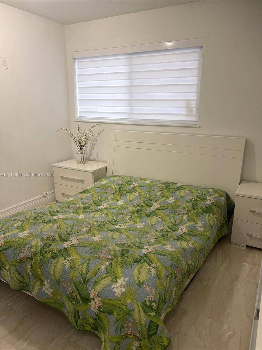 9961 SW 20th Street, Miami, Miami, FL 33165 Neutral-toned walls, light-toned flooring, and window featuring horizontal light-filtering blinds