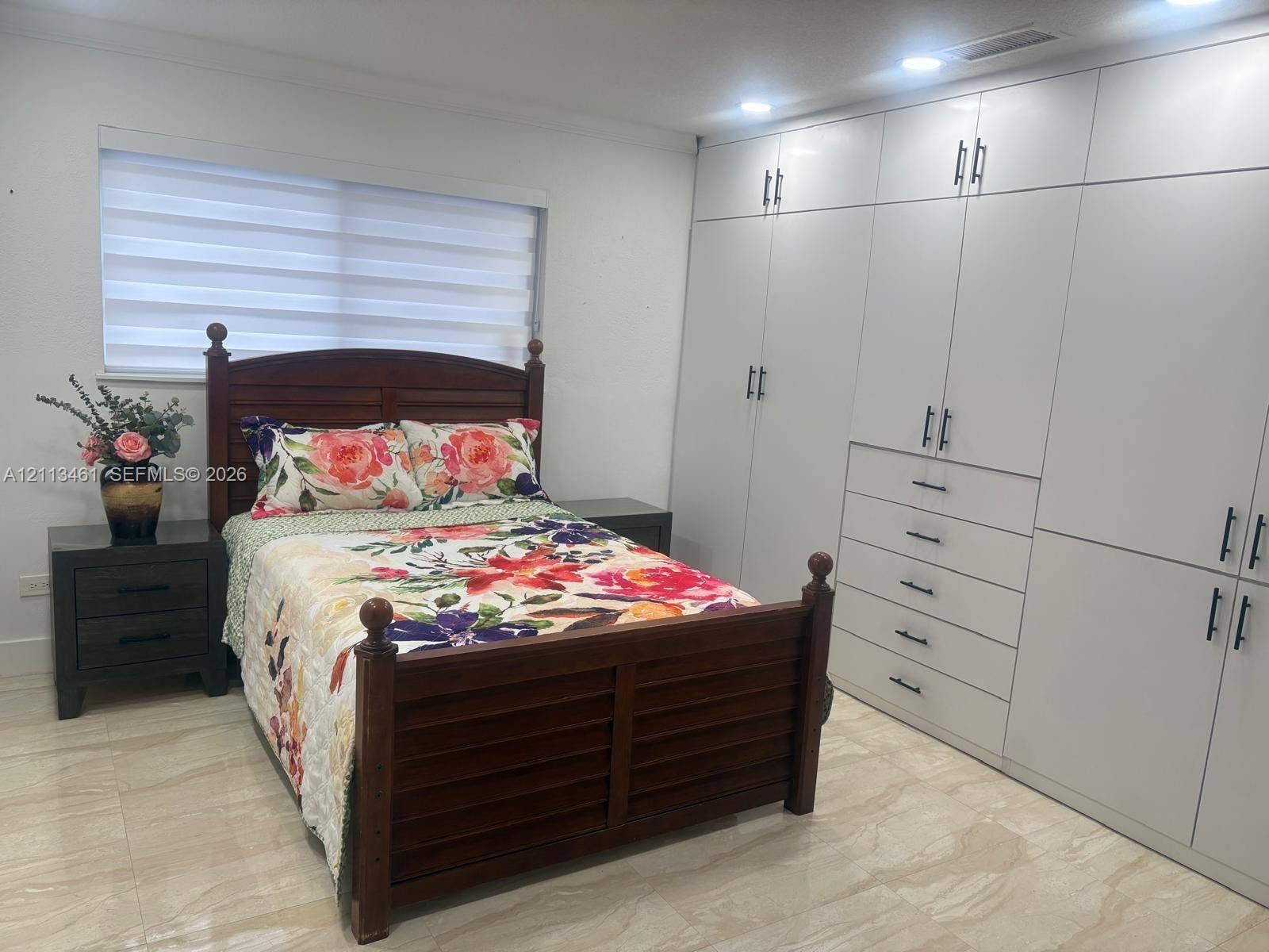 9961 SW 20th Street, Miami, Miami, FL 33165 Wall-to-wall built-in cabinetry featuring high-gloss white finish and matte black hardware, recessed ceiling lighting, and large-format tile flooring