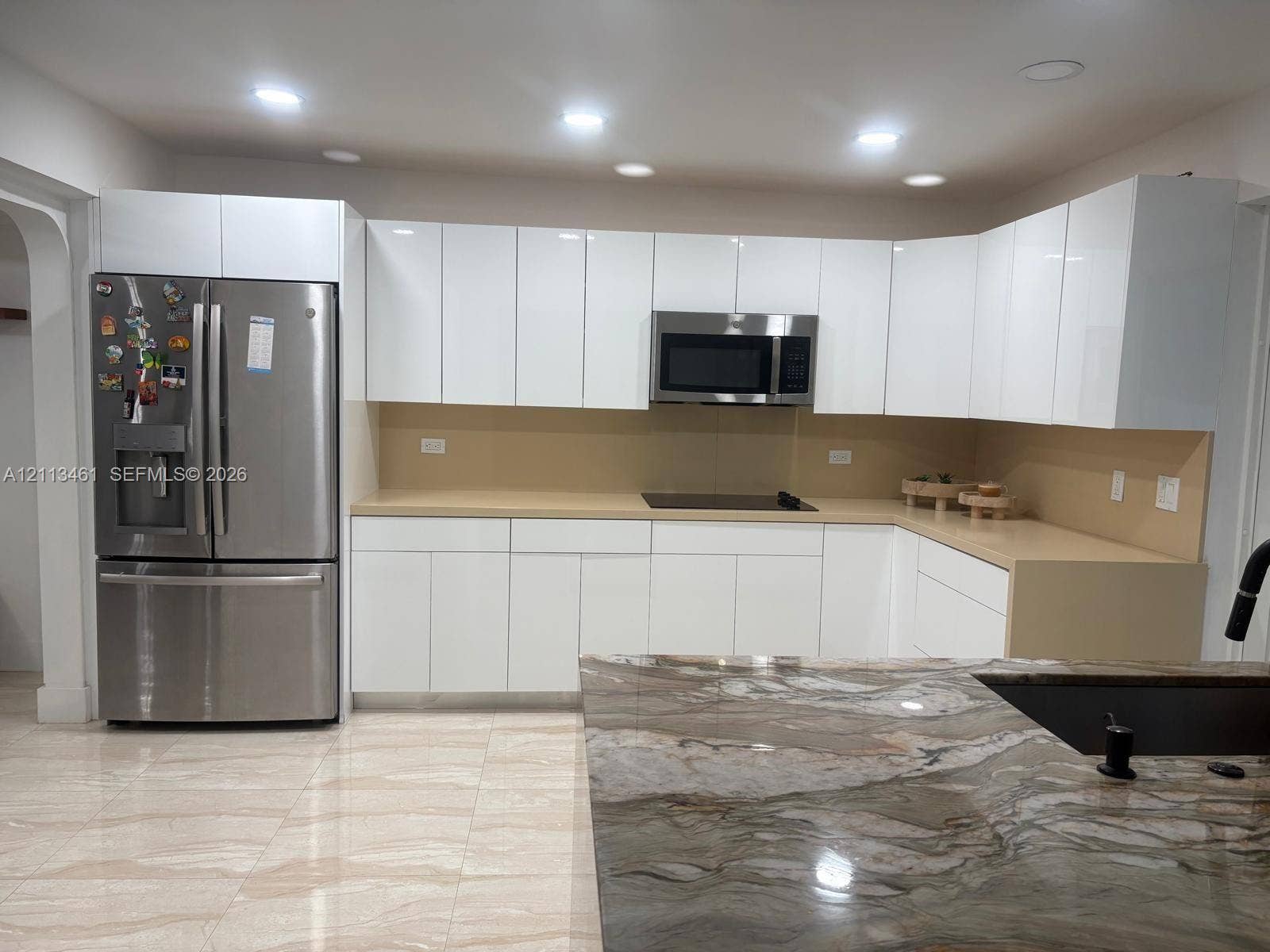 9961 SW 20th Street, Miami, Miami, FL 33165 Kitchen featuring white high-gloss cabinetry, stone-finish countertops, stainless steel appliances, a center island with a stone countertop, and tile flooring