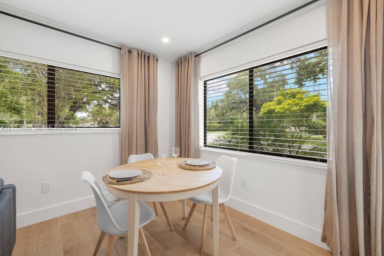 1505 SW 32nd Court, #1, Fort Lauderdale, Fort Lauderdale, FL 33315 Light-filled room featuring wood-finish flooring, recessed lighting, and large dual-pane windows with horizontal blinds