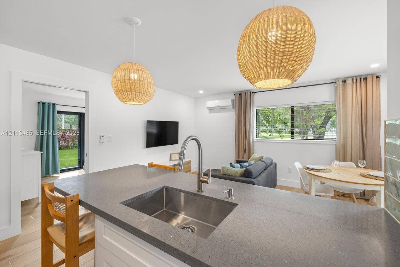 1505 SW 32nd Court, #1, Fort Lauderdale, Fort Lauderdale, FL 33315 Kitchen featuring a quartz countertop, stainless steel undermount sink, high-arc faucet, dual woven pendant lighting, and wood-finish flooring