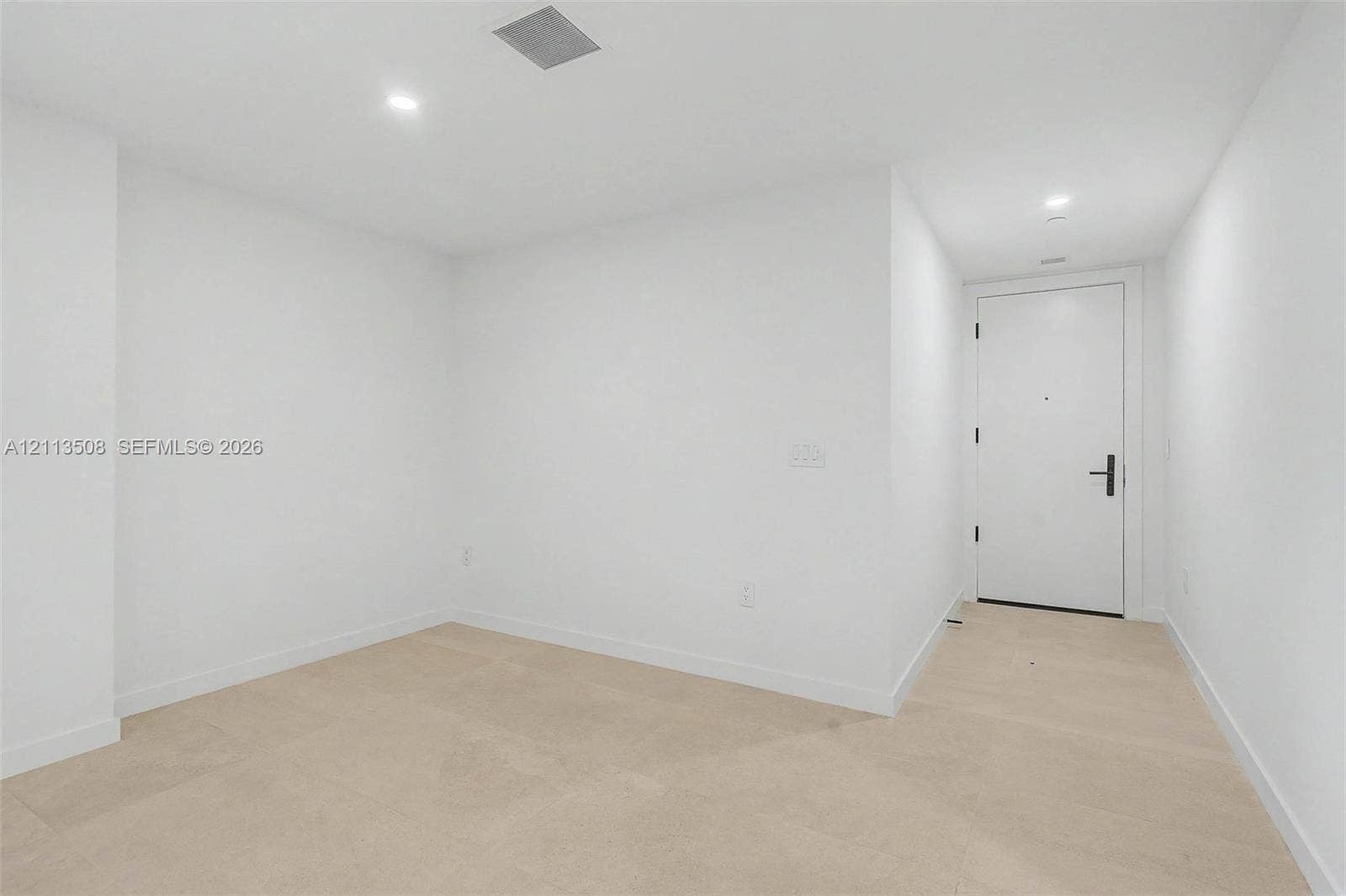 2200 Brickell Avenue, #405, Miami, Miami, FL 33129 Neutral interior featuring light-toned flooring, recessed lighting, and a solid-core door with matte black hardware