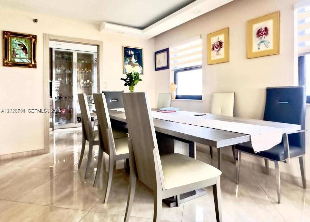 1201 S Ocean Drive, #2202S, Hollywood, FL 33019 Polished large-format tile flooring, recessed tray ceiling, and built-in glass-paneled cabinetry