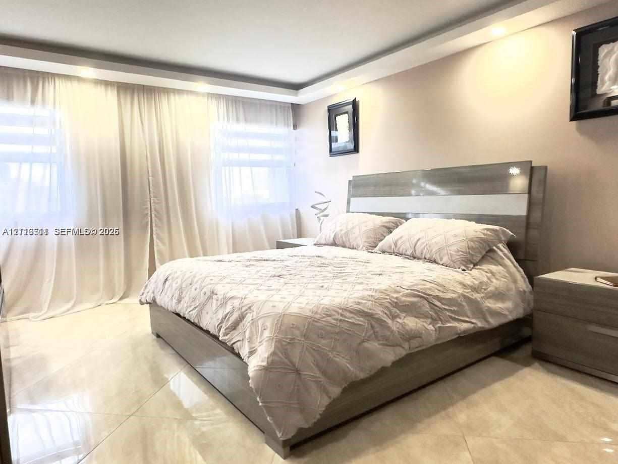 1201 S Ocean Drive, #2202S, Hollywood, FL 33019 Large-format tile flooring, tray ceiling with recessed lighting, and wall-to-wall drapery
