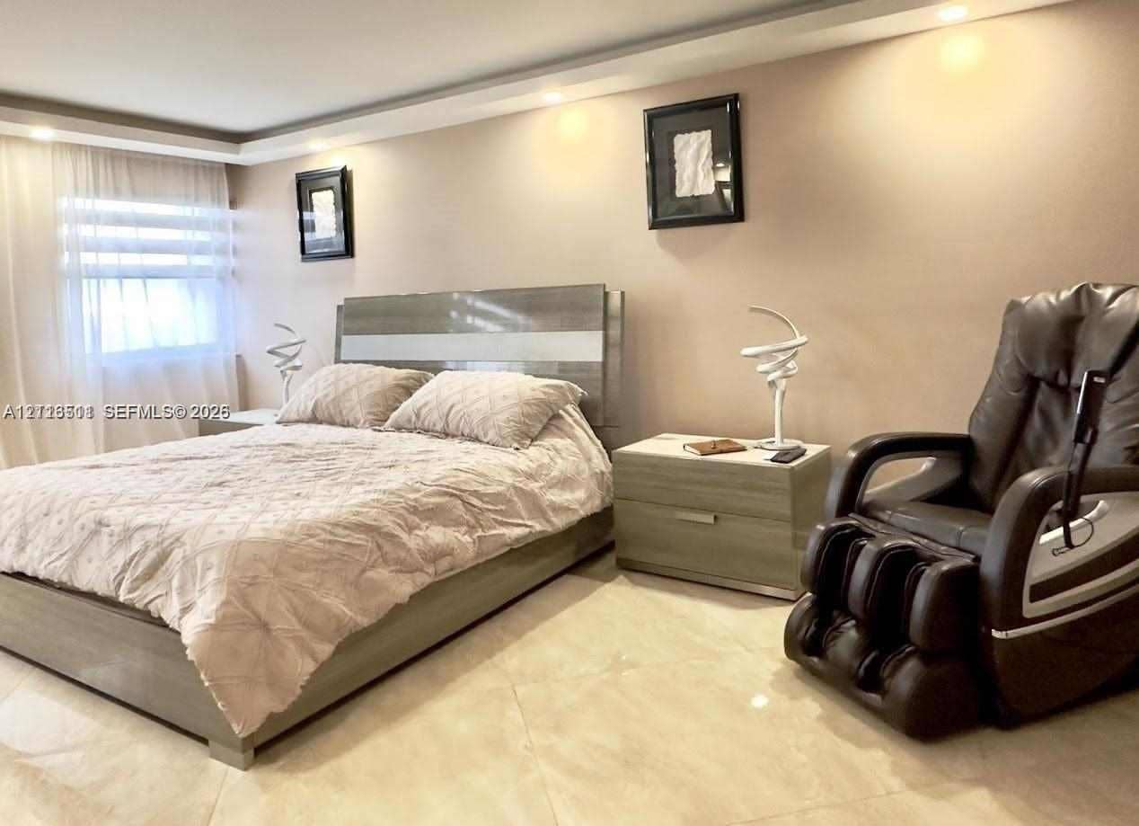 1201 S Ocean Drive, #2202S, Hollywood, FL 33019 Spacious bedroom featuring recessed ceiling lighting, large-format tile flooring, and a window fitted with horizontal blinds