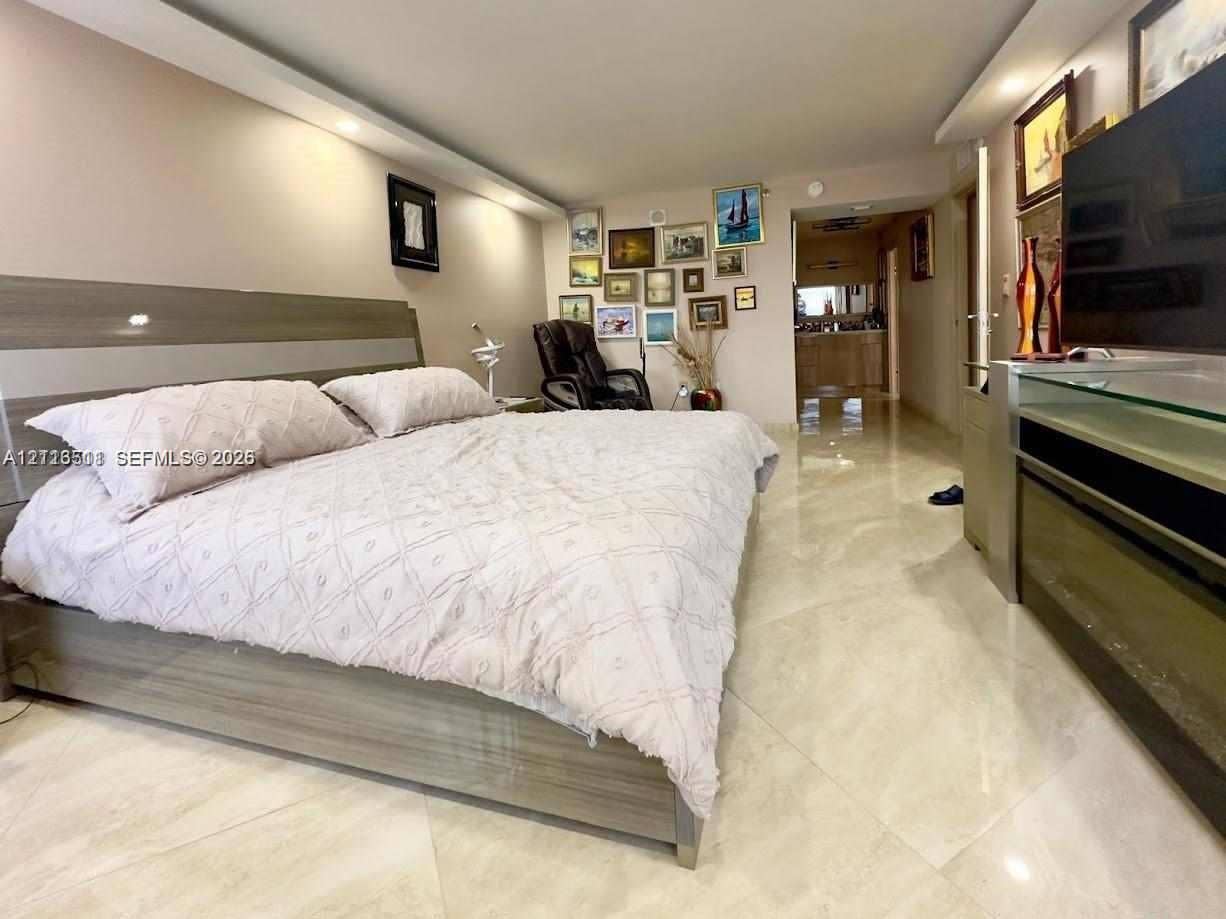 1201 S Ocean Drive, #2202S, Hollywood, FL 33019 Polished stone flooring, recessed ceiling lighting, and custom built-in cabinetry featuring a wood-grain finish