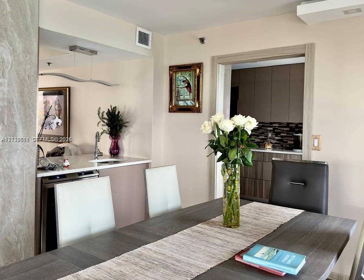 1201 S Ocean Drive, #2202S, Hollywood, FL 33019 Wet bar featuring stone countertops, an under-counter beverage cooler, and a stainless steel sink
