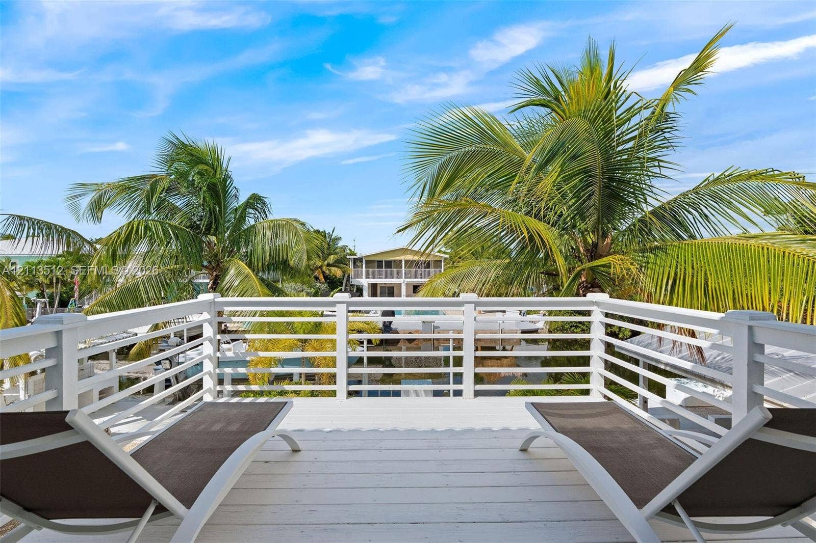 Key Largo, FL 33037 Elevated balcony featuring white painted wooden decking and white horizontal railing