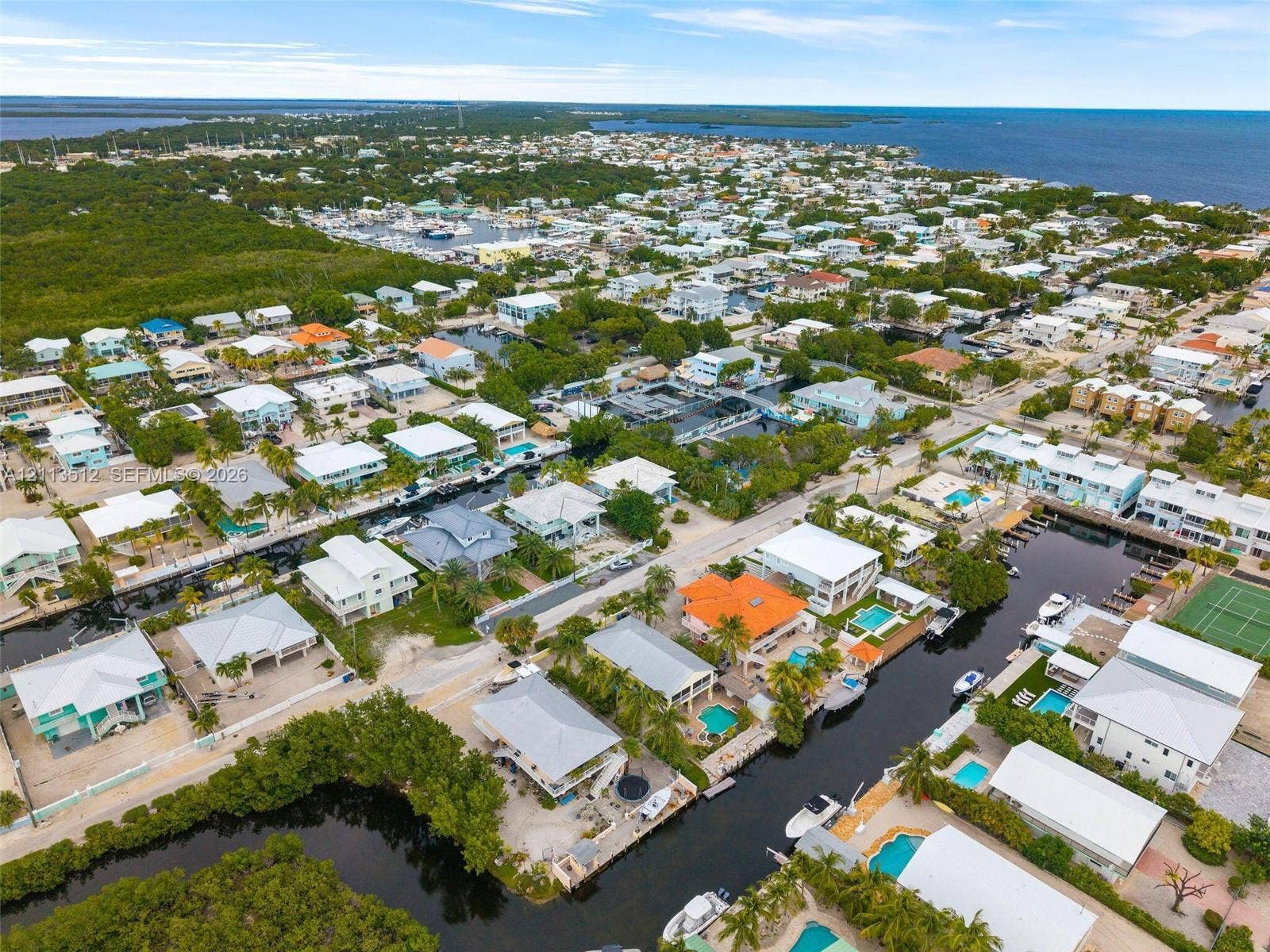 Key Largo, FL 33037 Aerial perspective of a coastal community featuring deep-water canal access, private boat docking, and open ocean exposure
