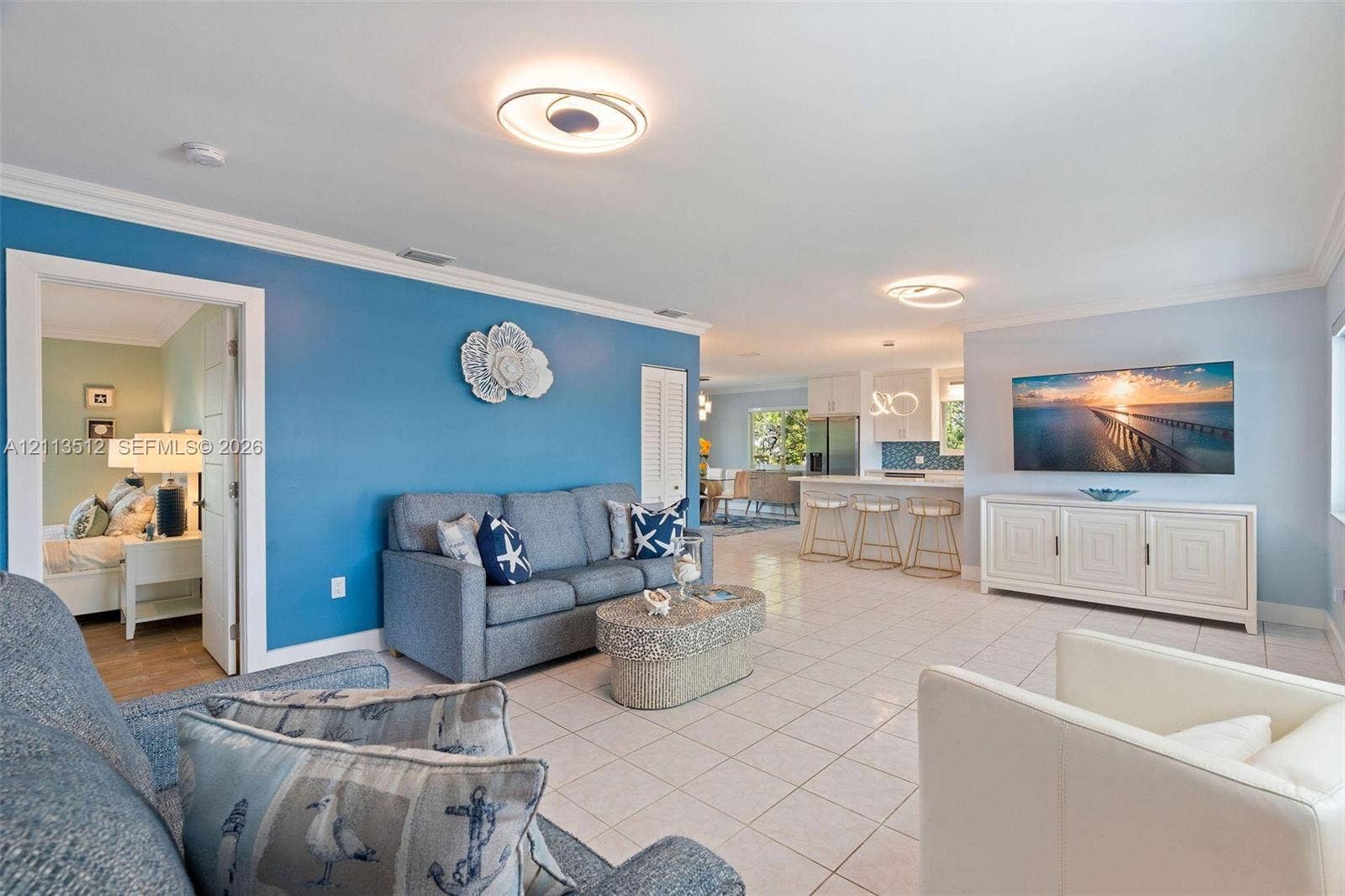 Key Largo, FL 33037 Open-concept interior featuring neutral tile flooring, recessed circular lighting fixtures, and crown molding