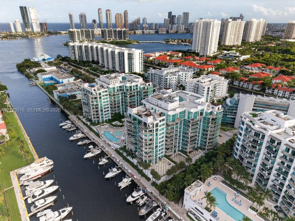 3131 NE 188th Street, #1-303, Aventura, FL 33180 Waterfront high-rise condominium complex featuring a deep-water marina, multiple swimming pools, tiered architectural balconies, and proximity to the Intracoastal Waterway