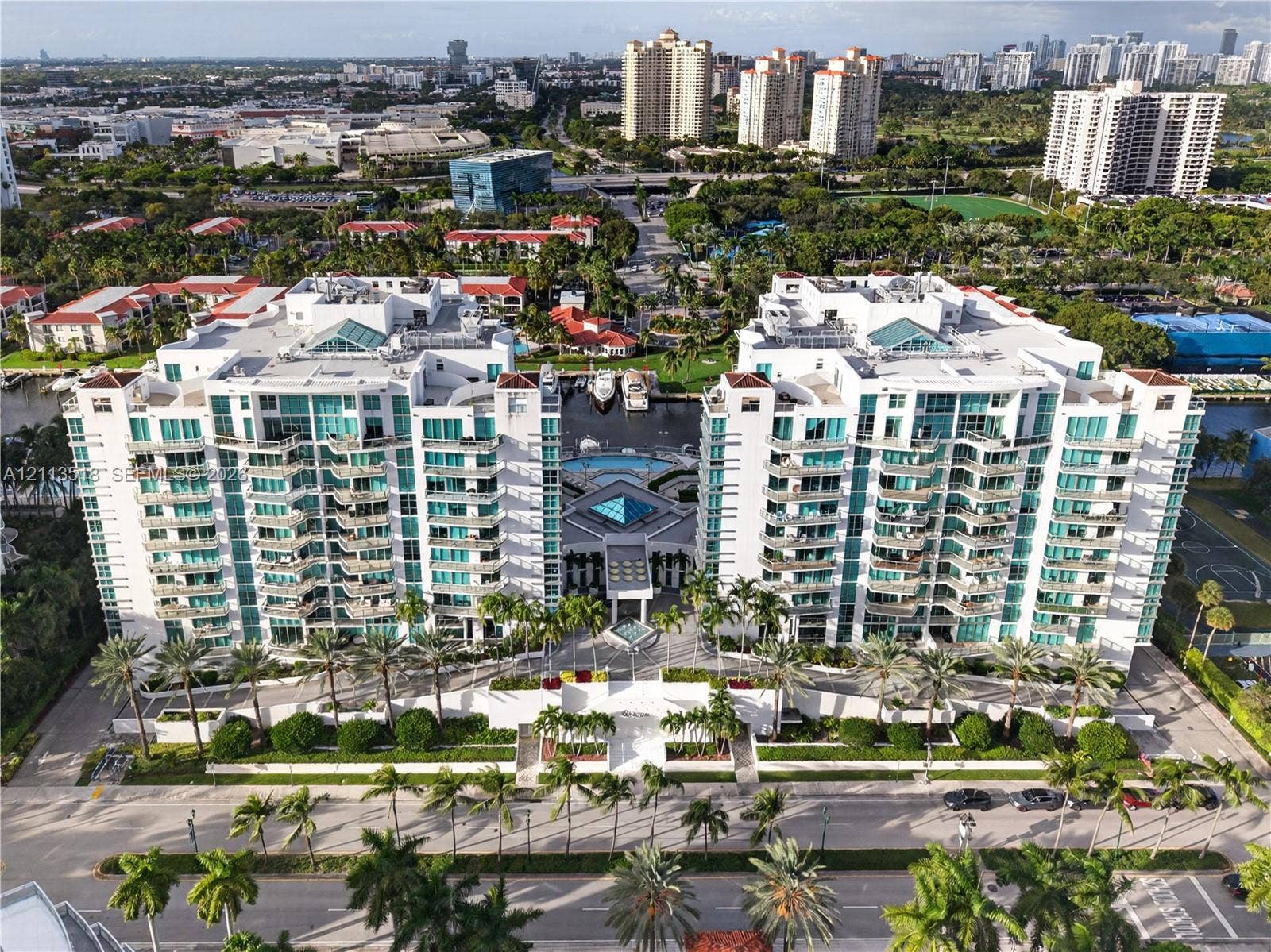 3131 NE 188th Street, #1-303, Aventura, FL 33180 High-rise waterfront residential complex featuring private balconies, an on-site swimming pool, deep-water boat slips, and extensive perimeter landscaping