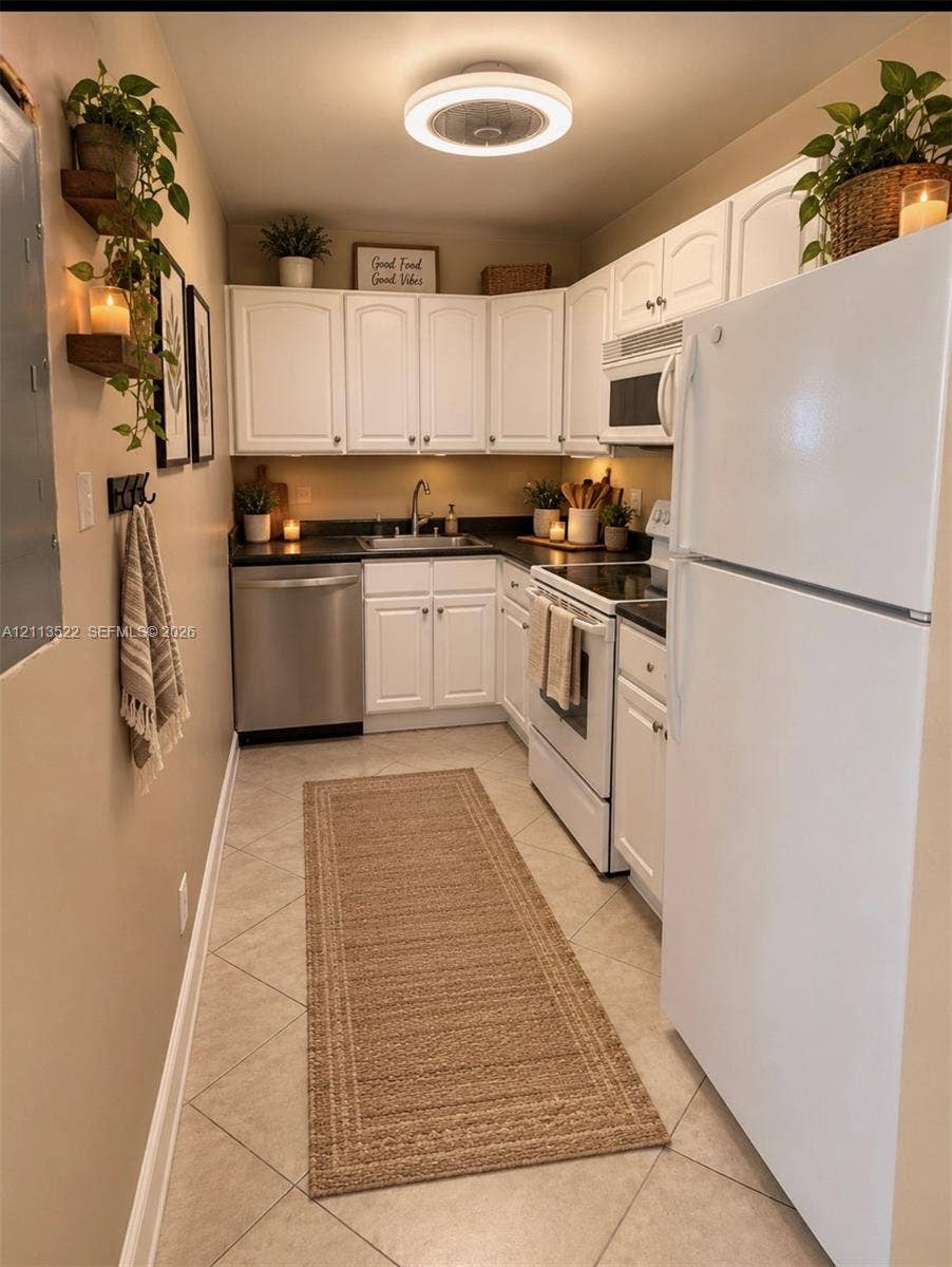 405 S Pine Island Road, #105D, Plantation, Plantation, FL 33324 Kitchen featuring white cabinetry, dark countertops, tile flooring, stainless steel dishwasher, and a flush-mount overhead light fixture